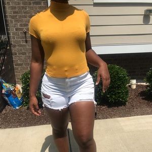 Yellow turtle neck, rigged top with ruffle details